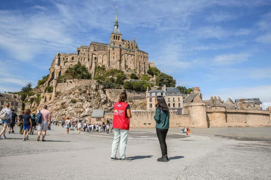 From Paris: Mont Saint-Michel Tour with Hotel Pickup Service - Guided abbey tour: 11th-century buildings, Gothic cloisters, and the refectory