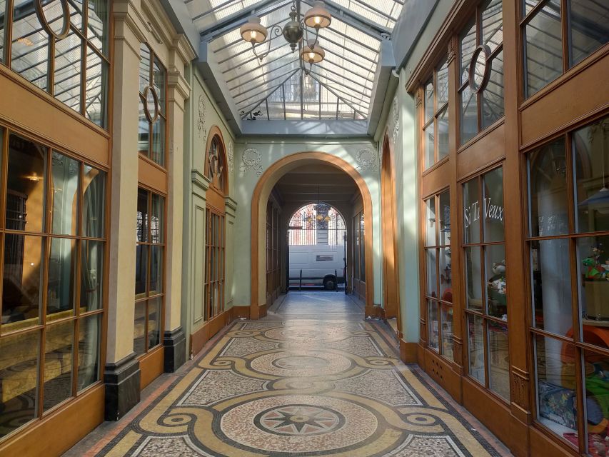 Paris: Covered Passages Walking Tour - Passage Choiseul: Glass Roof Light, Ornate Tiles, and Shop Stretches